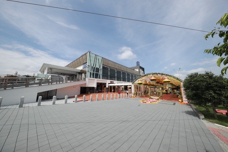 V Legacy Convention Center and its paved forecourt under a blue sky