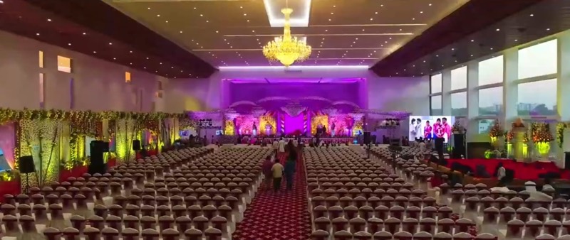 Grand Hall stage lit in violet beneath a chandelier